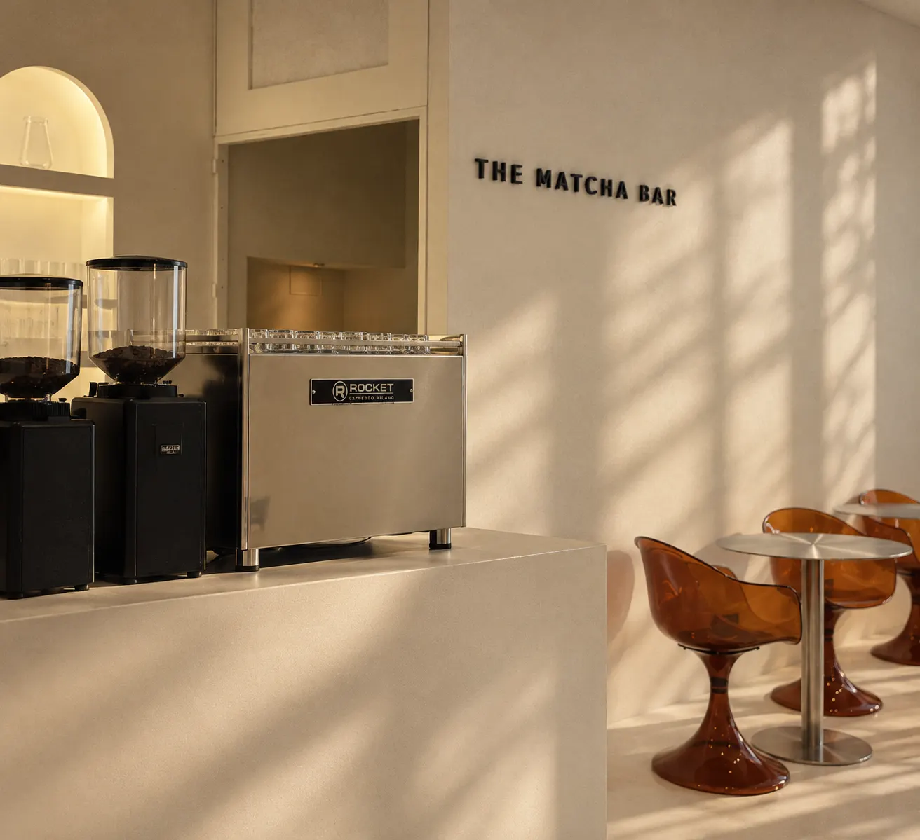The Matcha Bar counter with grinders and amber chairs