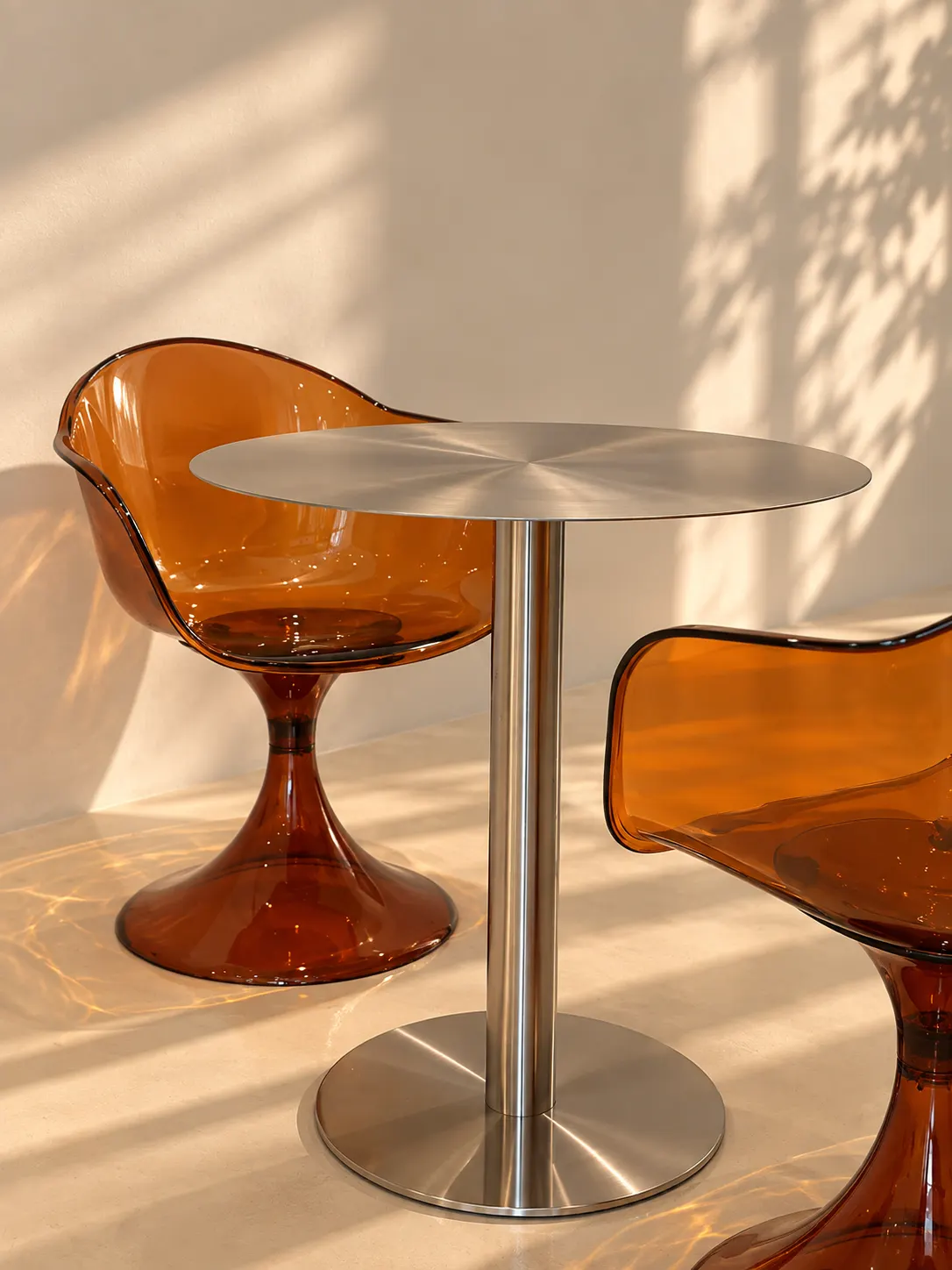 Amber acrylic chairs around a chrome café table in the wellness bar